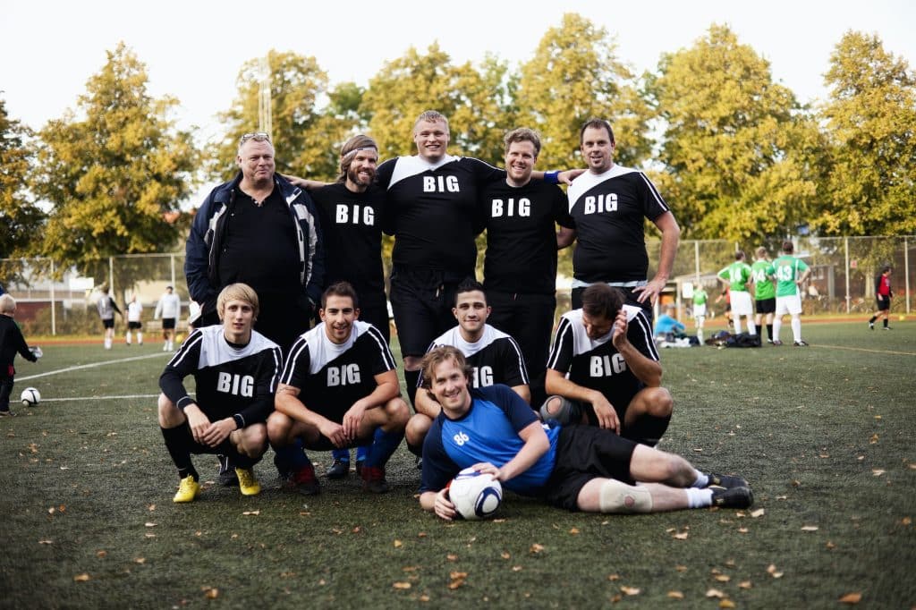 Portrait of happy soccer team at field